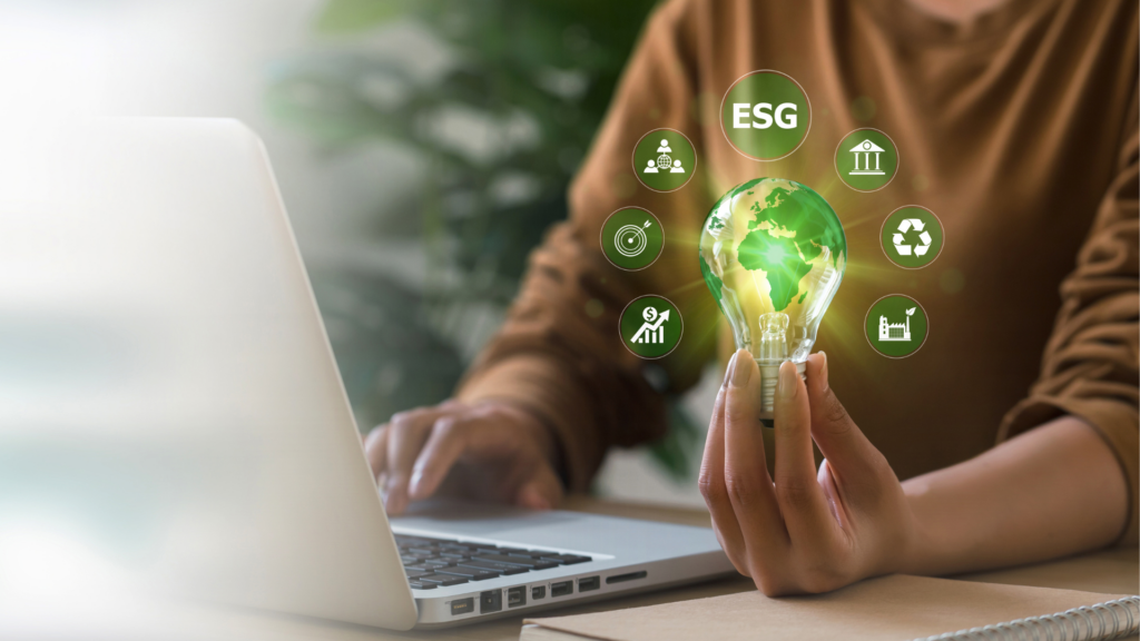 A person holds a green illuminated bulb radiating different icons symbolising ESG